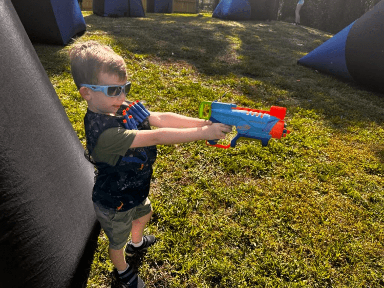 Smiling kids with safety goggles and Nerf party rentals in DeLand, FL.